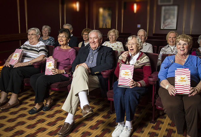 Residents enjoy the community movie theatre and popcorn