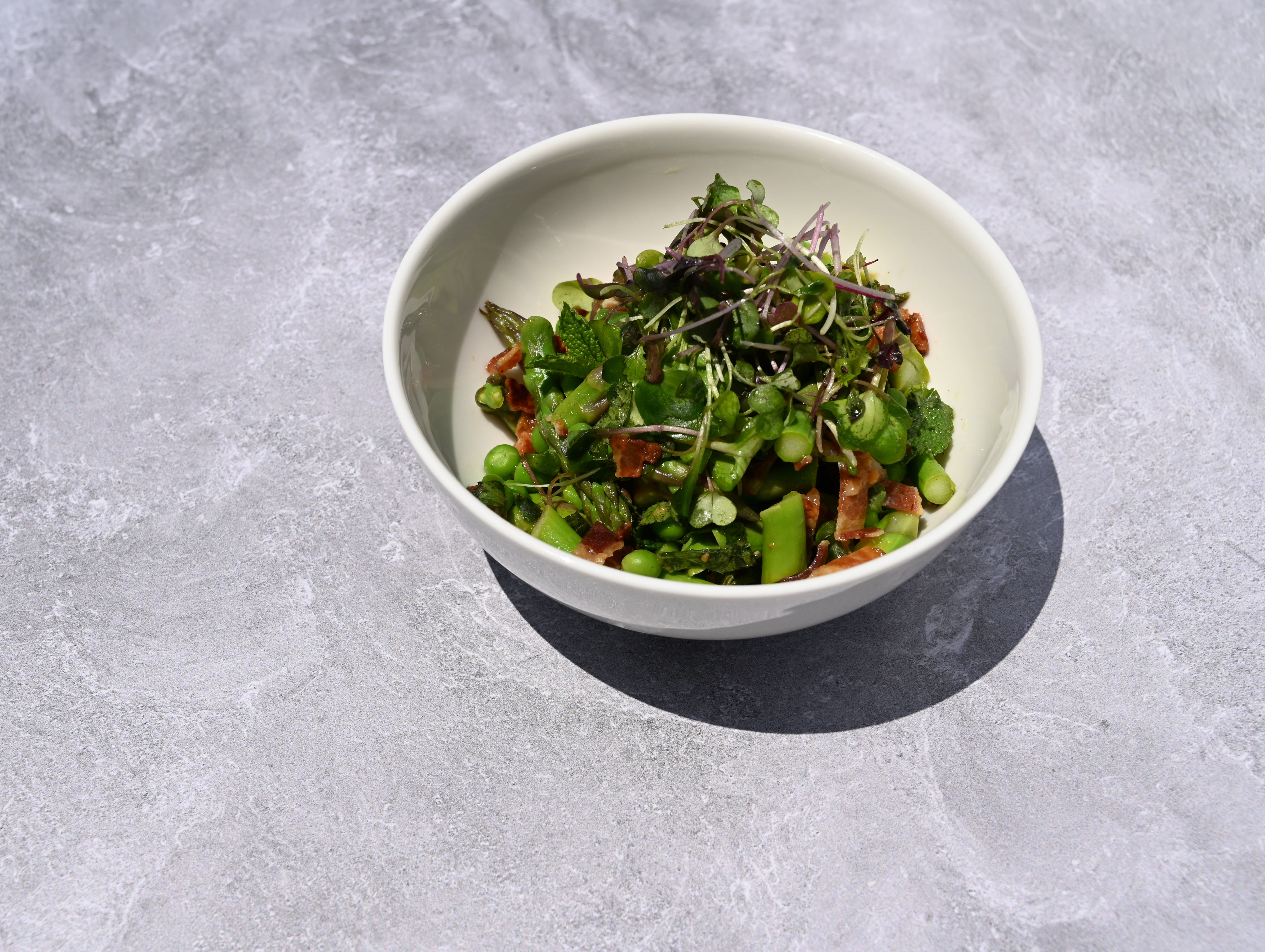 A colorful salad on a stone background in a bowl